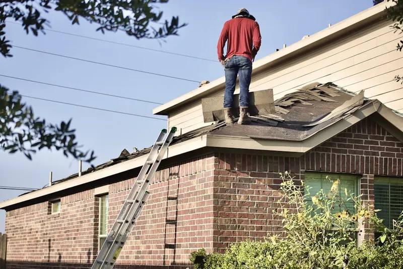 Professional roofer working on a residential roof in Washington-Rosedale